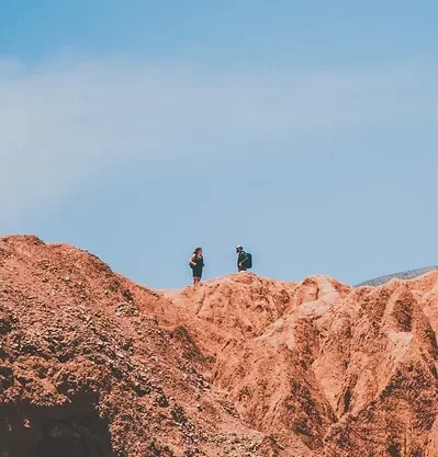 people walking on an arid stone landscape