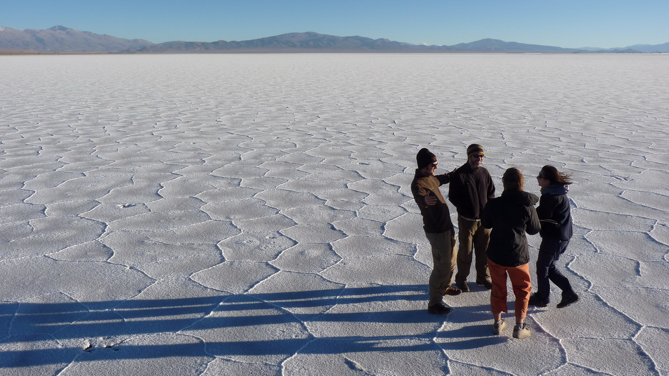 image of the salt flats with a group of people having fun at sunset