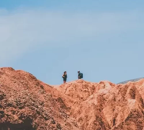people walking on an arid stone landscape